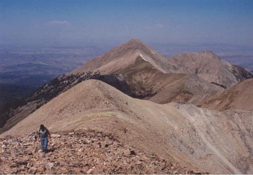 Allen approaching Peale summit with Tukuhnikivatz in background